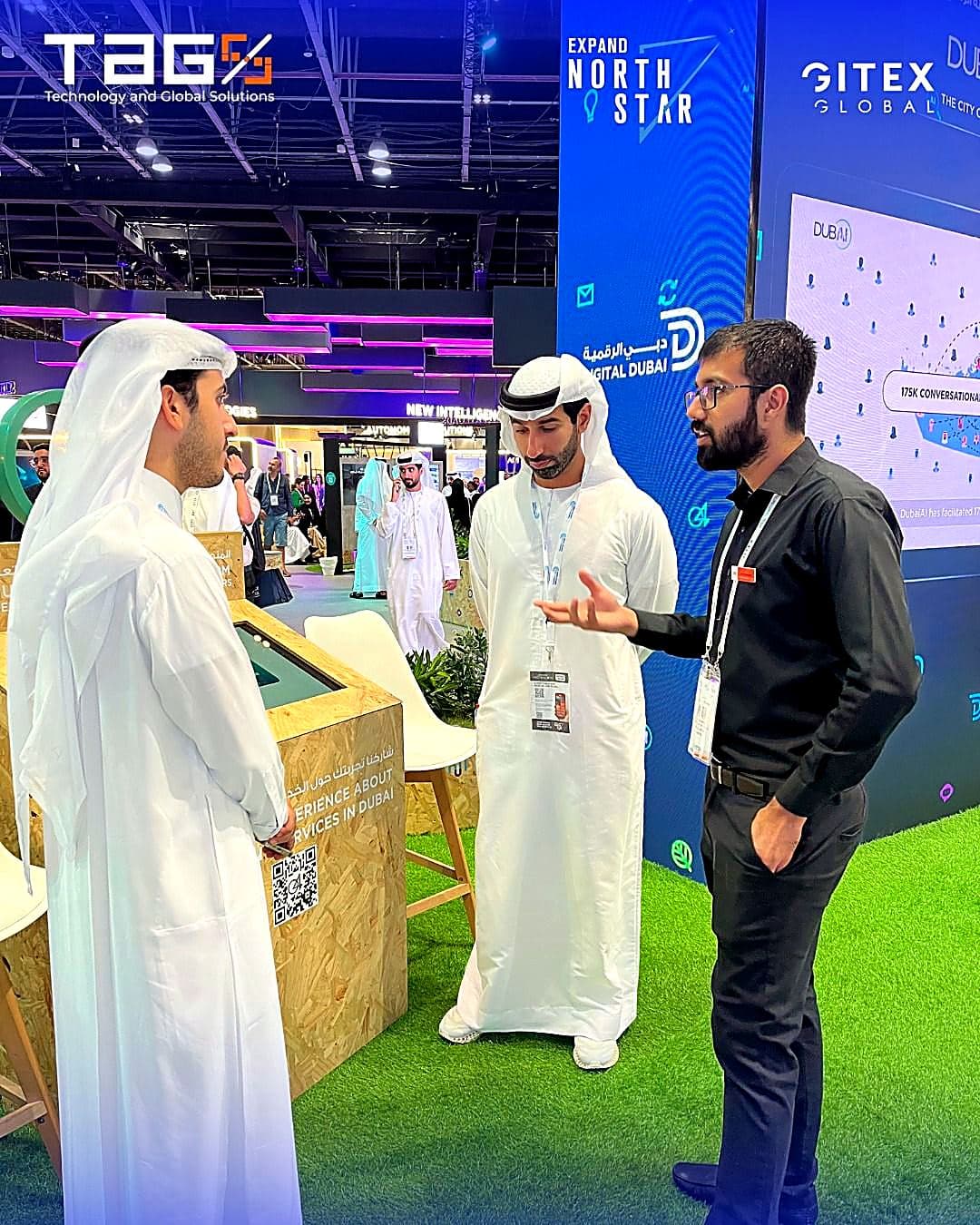 Conversation with delegates at the Digital Dubai stand during GITEX Global