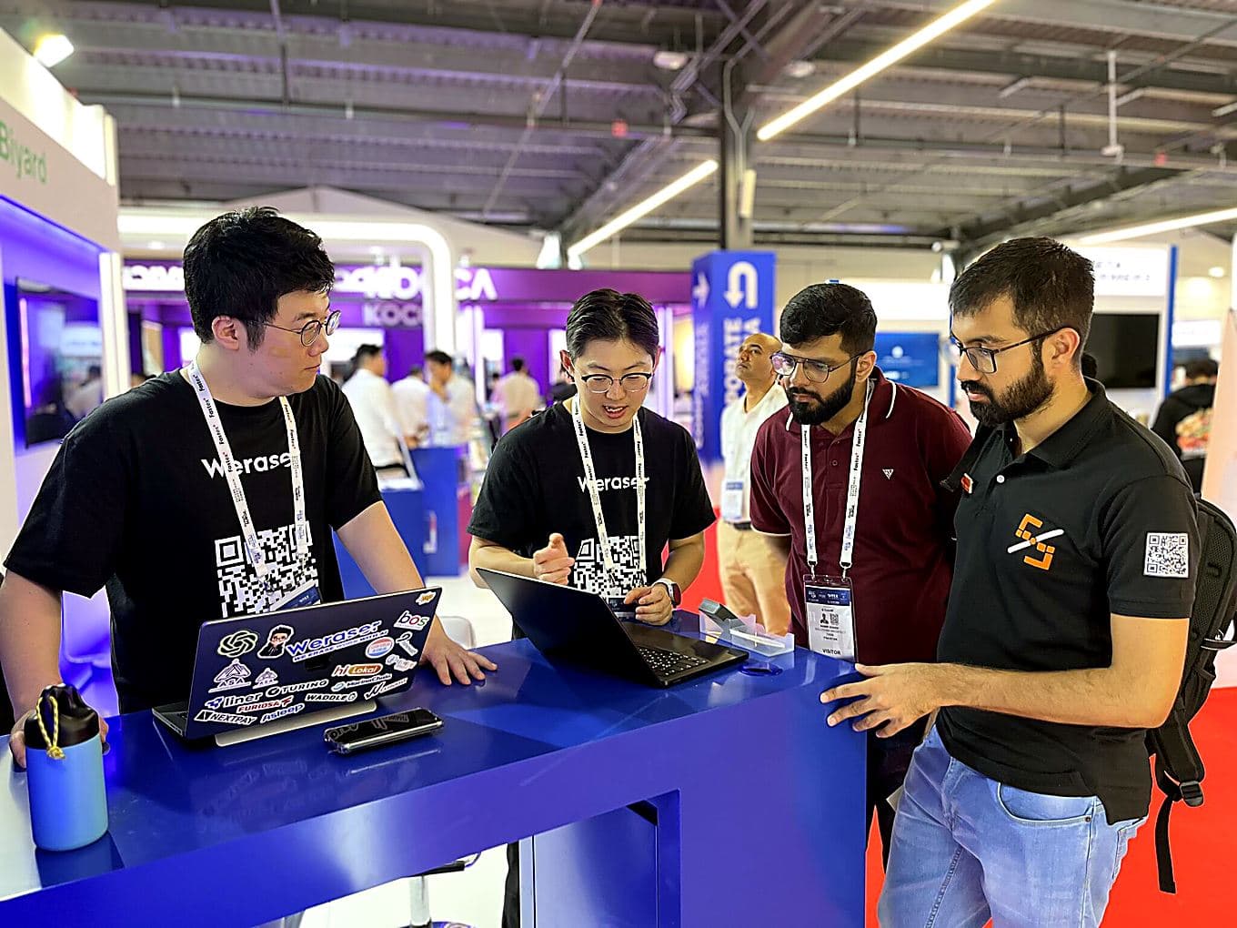 Working through a platform demo with a partner team at their stand