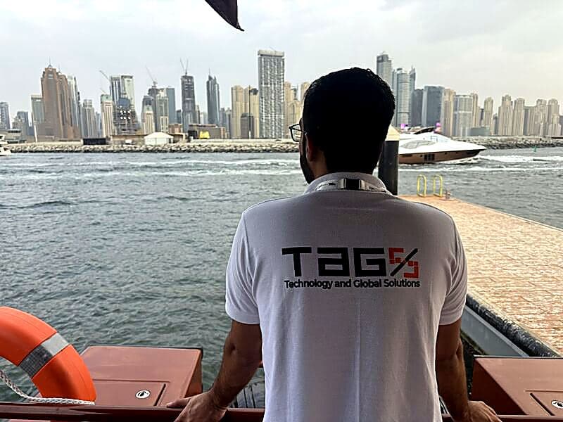 Looking out over the Dubai skyline from the water, wearing a TAG Solutions shirt